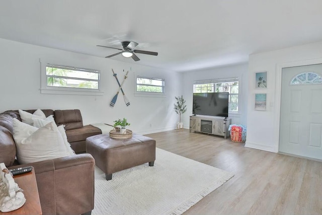 living room with ceiling fan and light hardwood / wood-style flooring