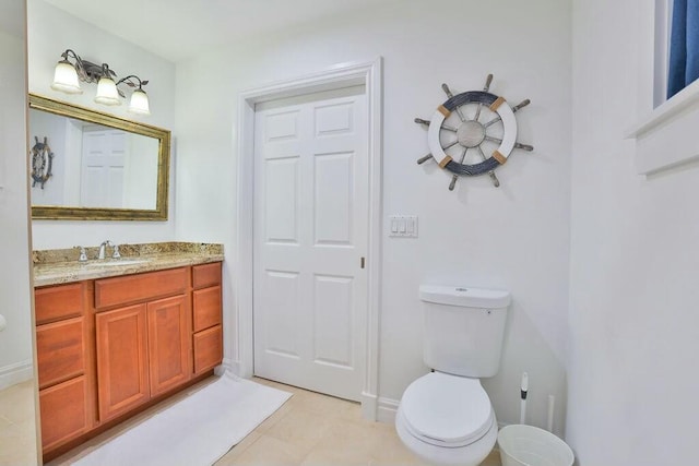 bathroom featuring tile patterned flooring, vanity, and toilet