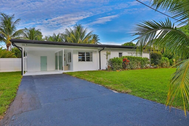 view of front facade with a carport and a front yard