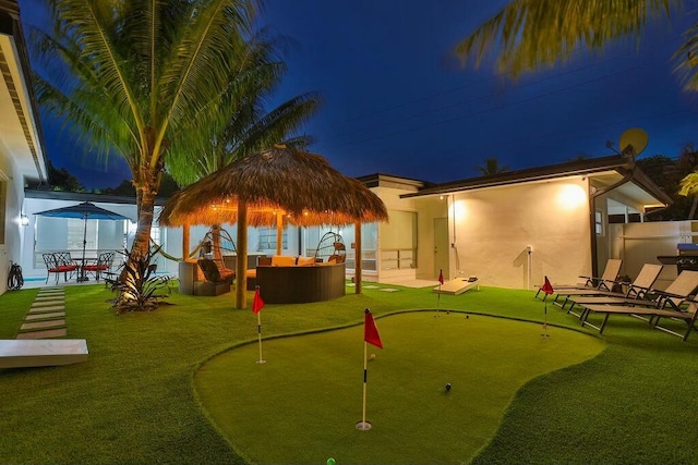 back house at twilight featuring outdoor lounge area