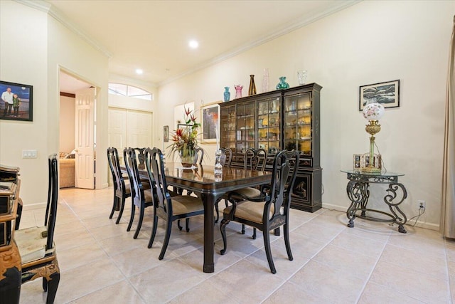 dining space with light tile patterned floors and ornamental molding