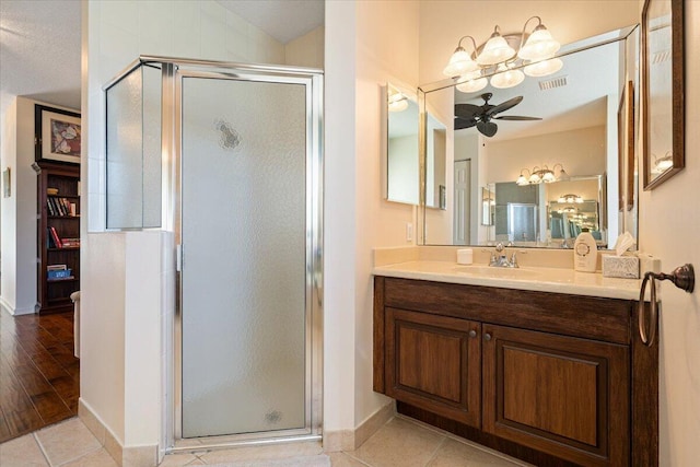 bathroom featuring hardwood / wood-style floors, vanity, ceiling fan, and a shower with shower door