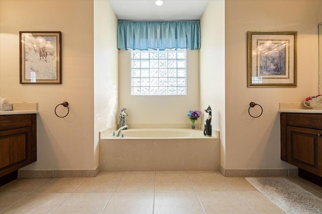 bathroom featuring tile patterned floors, vanity, and a tub to relax in