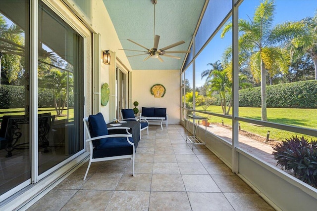 sunroom with ceiling fan and vaulted ceiling