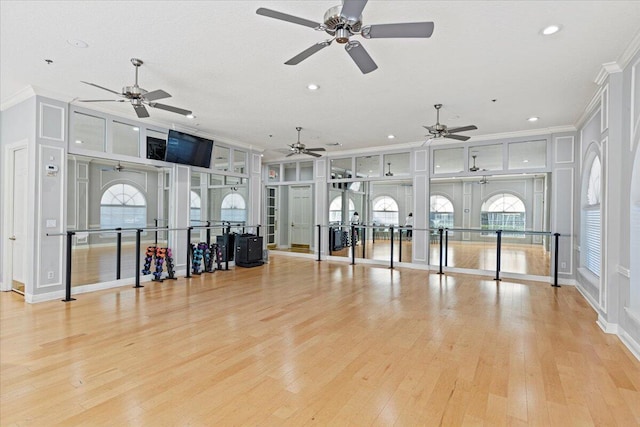 interior space with crown molding, light hardwood / wood-style flooring, and french doors