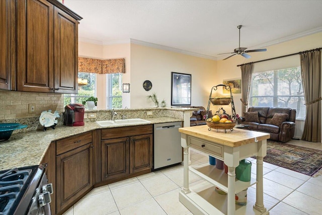 kitchen featuring plenty of natural light, ornamental molding, sink, and appliances with stainless steel finishes