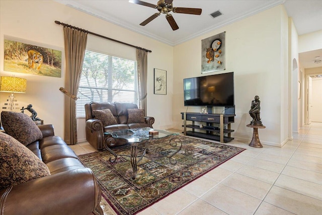 living room featuring ceiling fan, ornamental molding, and light tile patterned flooring