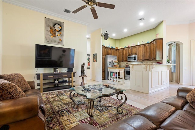 living room featuring ceiling fan, ornamental molding, and light tile patterned floors