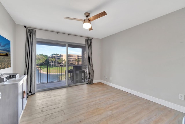 empty room featuring ceiling fan and light hardwood / wood-style flooring