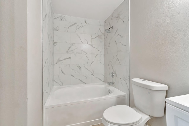 full bathroom with vanity, tiled shower / bath combo, and toilet