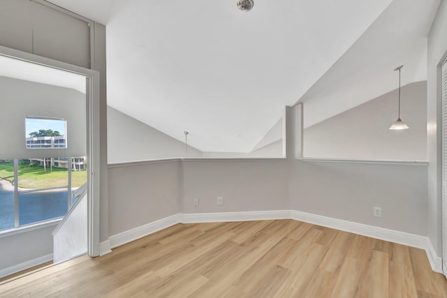 interior space featuring hardwood / wood-style floors and vaulted ceiling