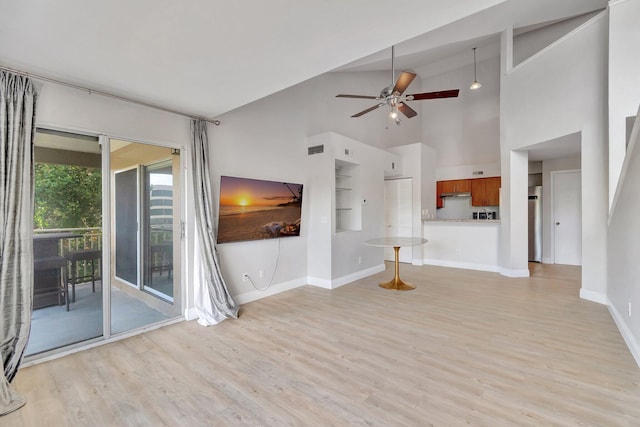 unfurnished living room with built in shelves, high vaulted ceiling, light hardwood / wood-style flooring, and ceiling fan