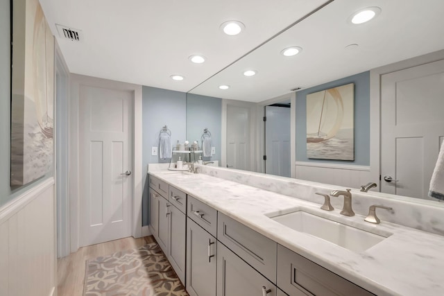 bathroom with hardwood / wood-style flooring and vanity