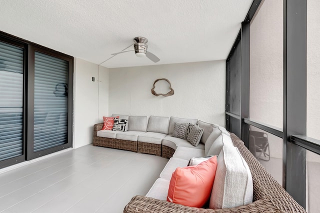 sunroom featuring ceiling fan