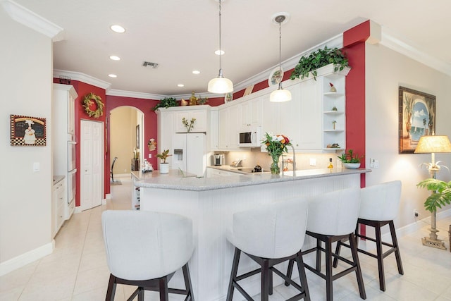 kitchen featuring kitchen peninsula, backsplash, ornamental molding, white appliances, and white cabinets