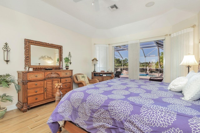 bedroom featuring ceiling fan, light hardwood / wood-style floors, and access to outside