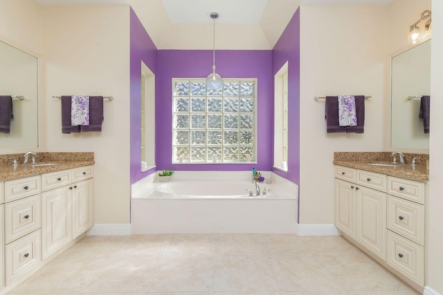 bathroom with a bath, vanity, and tile patterned floors