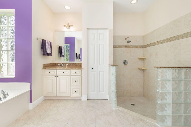 bathroom with tile patterned flooring, vanity, and separate shower and tub