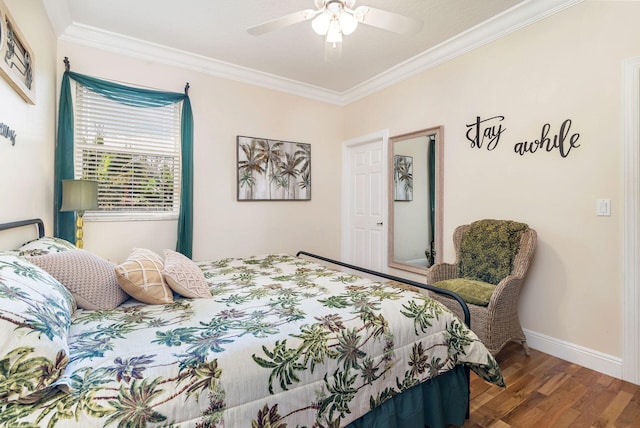 bedroom featuring ceiling fan, hardwood / wood-style floors, and ornamental molding