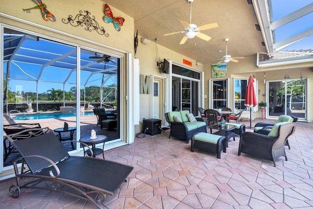 view of patio / terrace with glass enclosure, ceiling fan, and an outdoor living space