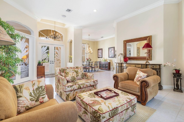 tiled living room with crown molding, french doors, and an inviting chandelier