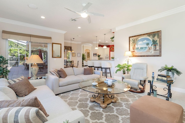 living room featuring ceiling fan and crown molding