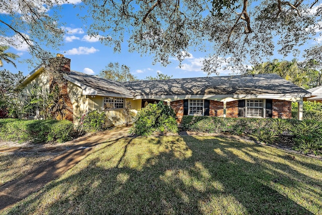 rear view of property featuring a yard