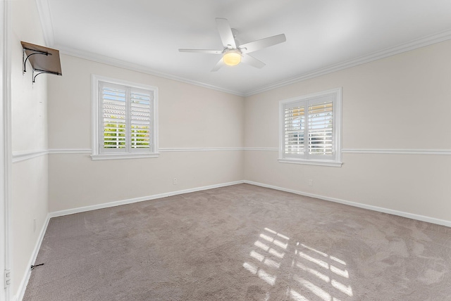 unfurnished room featuring ceiling fan, light colored carpet, a healthy amount of sunlight, and ornamental molding