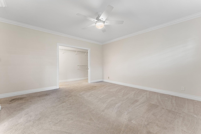 unfurnished bedroom featuring ceiling fan, a closet, light colored carpet, and ornamental molding