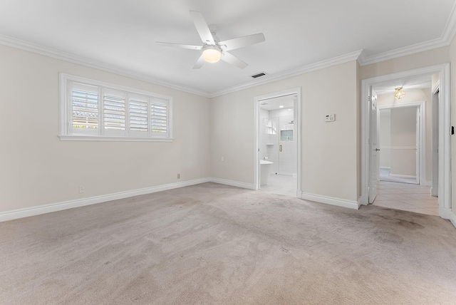 carpeted spare room with ceiling fan and ornamental molding