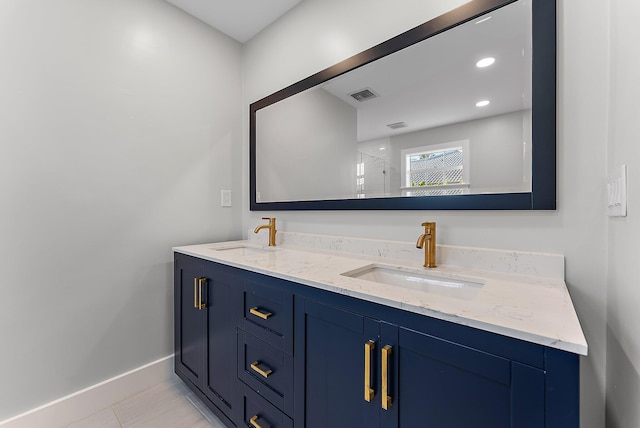 bathroom featuring tile patterned flooring and vanity