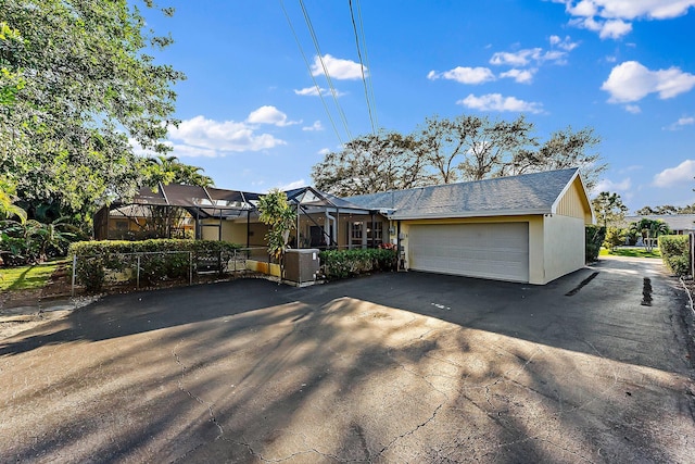 back of property featuring a yard and glass enclosure