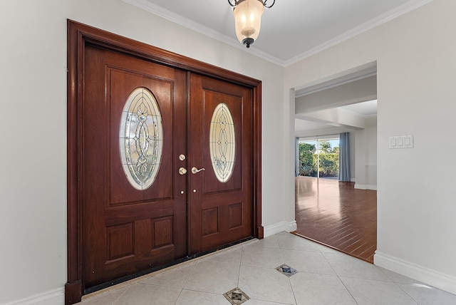 entryway featuring light wood-type flooring and ornamental molding