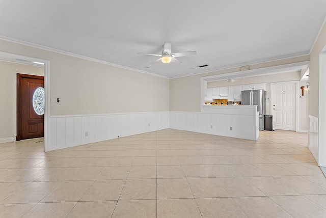 unfurnished living room with ceiling fan, ornamental molding, and light tile patterned floors