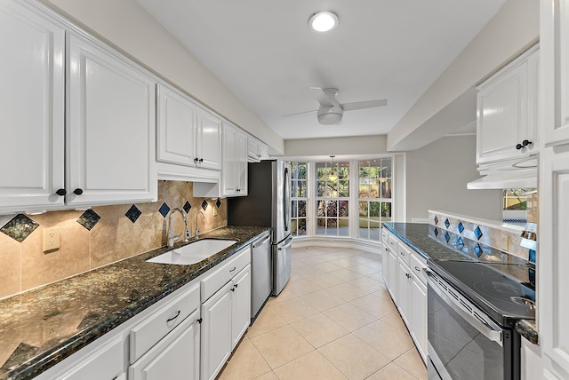 kitchen featuring stainless steel appliances, ceiling fan, sink, white cabinets, and light tile patterned flooring