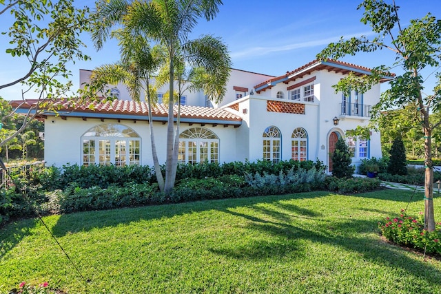 230 Argyle Rd, West Palm Beach, FL 33405 - mediterranean / spanish-style home with stucco siding, a tiled roof, and a front yard