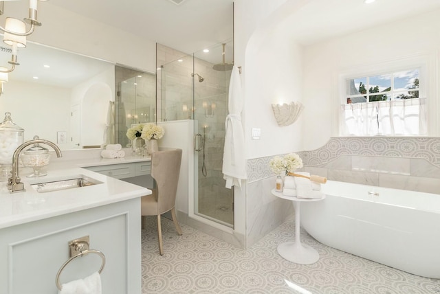 230 Argyle Rd, West Palm Beach, FL 33405 - bathroom featuring a shower stall, a freestanding bath, vanity, and recessed lighting