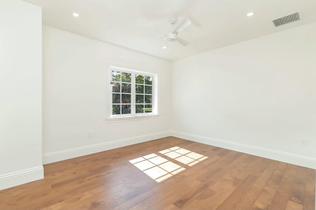 empty room featuring ceiling fan and hardwood / wood-style floors