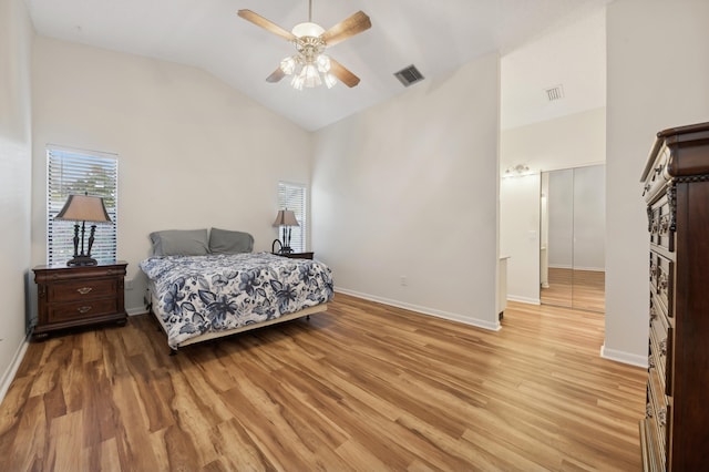 bedroom with ceiling fan, light hardwood / wood-style floors, and lofted ceiling