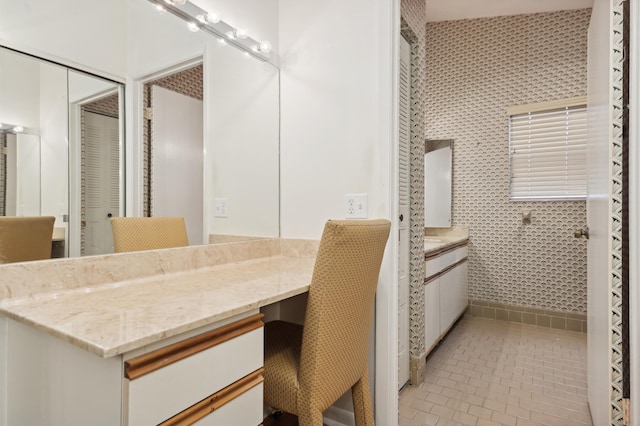 bathroom with tile patterned floors, vanity, and tile walls