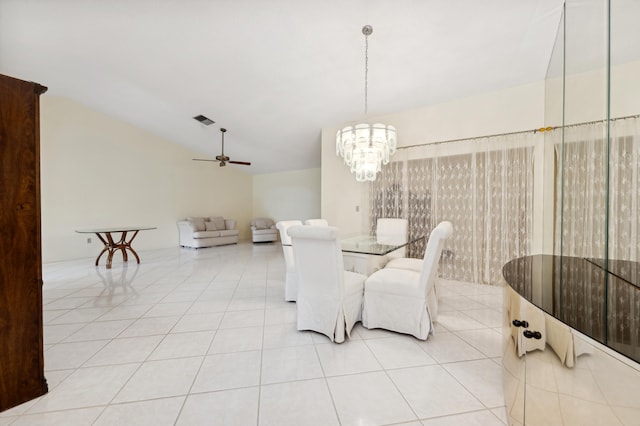 tiled dining room with ceiling fan with notable chandelier