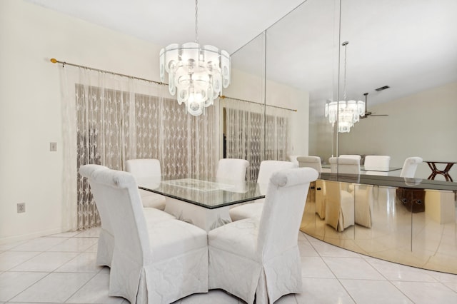 tiled dining area featuring a chandelier