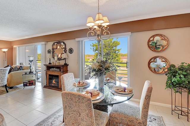 dining area featuring a chandelier, light tile patterned floors, a healthy amount of sunlight, and a textured ceiling