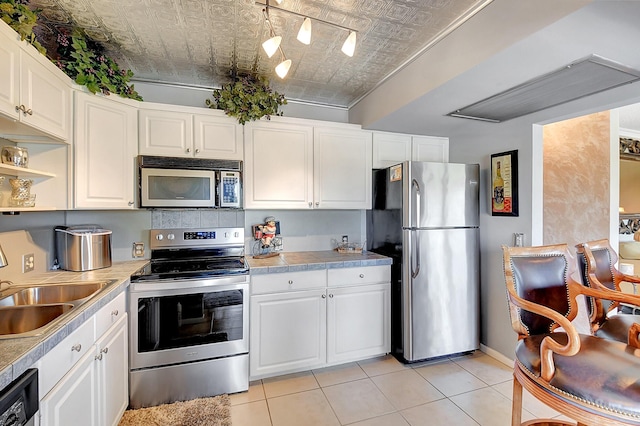 kitchen with white cabinets, stainless steel appliances, and sink