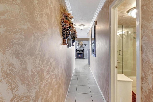 hallway featuring a textured ceiling, light tile patterned flooring, and crown molding