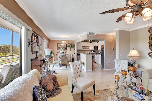 living room with ceiling fan with notable chandelier, light tile patterned flooring, ornamental molding, and a textured ceiling