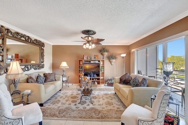 living room featuring ceiling fan, light tile patterned floors, a textured ceiling, and ornamental molding