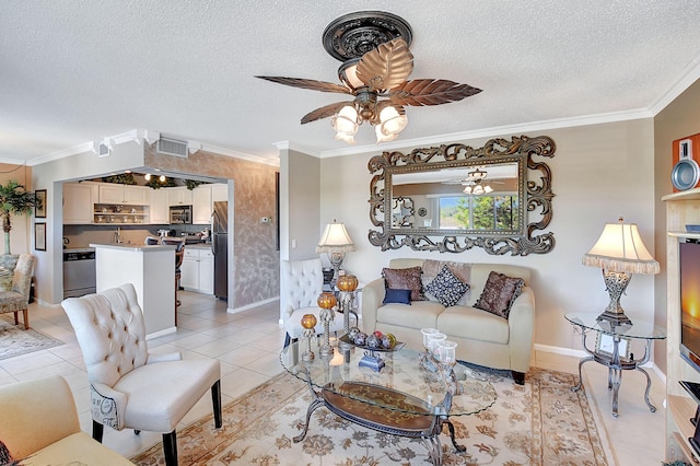 living room featuring crown molding, light tile patterned floors, ceiling fan, and a textured ceiling