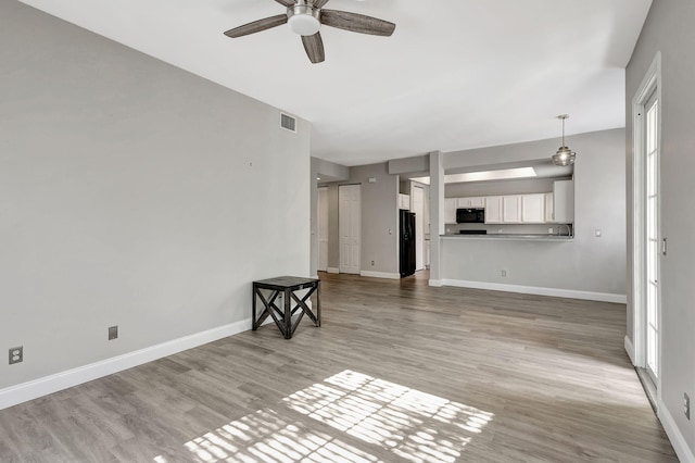 unfurnished living room with ceiling fan, a healthy amount of sunlight, and light hardwood / wood-style floors