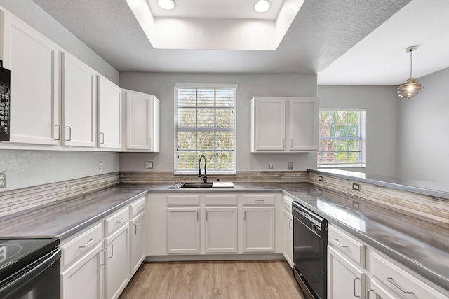 kitchen featuring white cabinets, sink, plenty of natural light, and black appliances